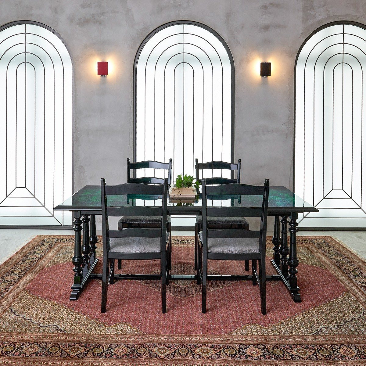 Urushi dining table and chairs on a red rug, in a room with arched windows